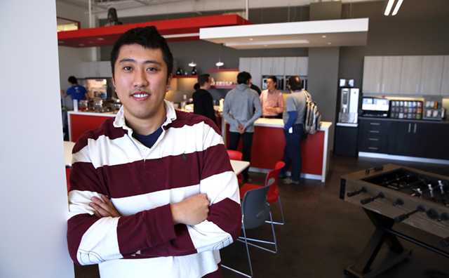 Derek Ting standing in front of TextNow's kitchen