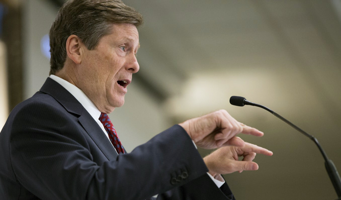 Side profile of Toronto Mayor John Tory at podium