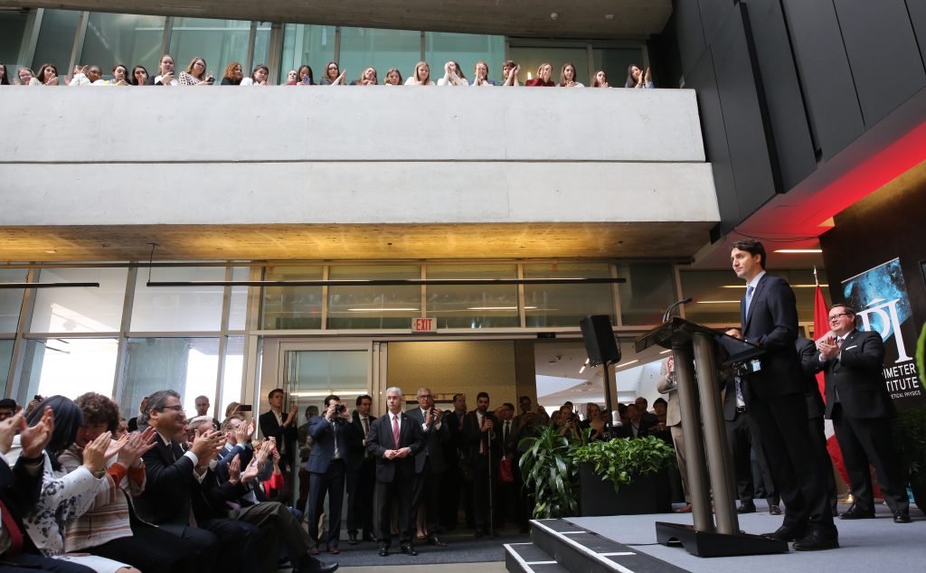 Justin Trudeau giving a speech in front of a crowd.