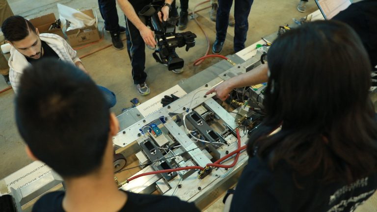 An overhead shot of people working on building a machine.